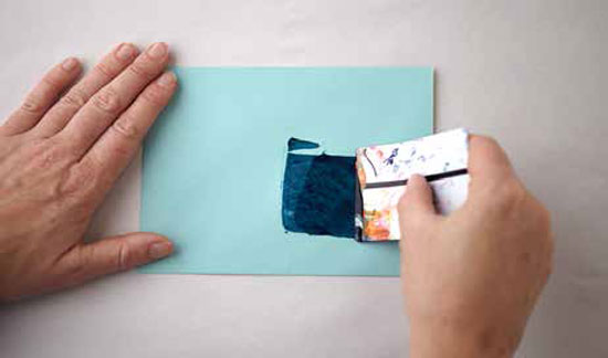 For an extra punch of color, use your credit card to apply a quick swatch of paint to your envelopes.